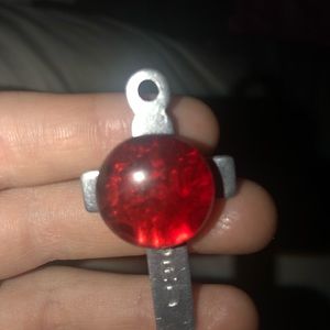 Cross pin with red stone